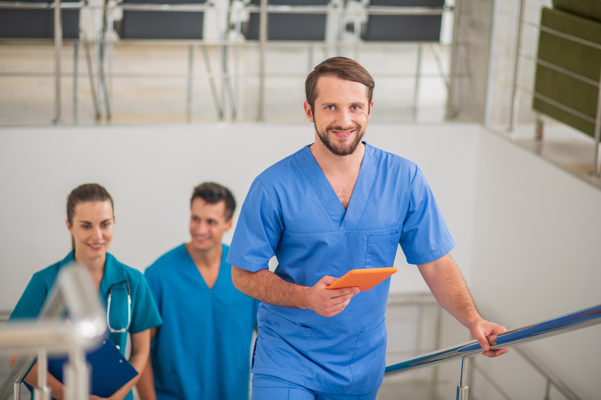 Three doctors going up the stairs and talking