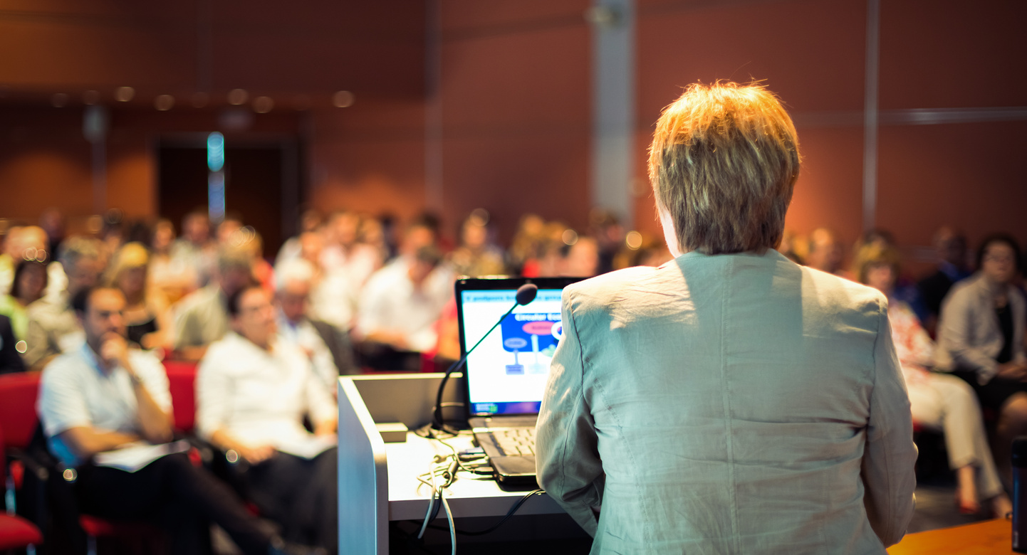 Woman Lecturing at Conference